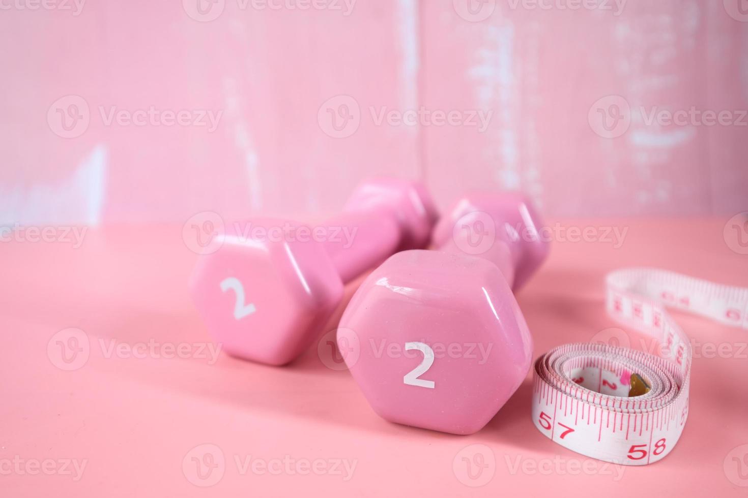 Two pound dumbbells on pink background photo