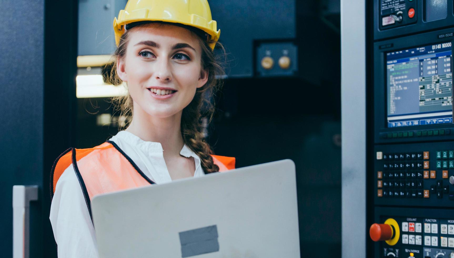 Construction worker with a laptop and hardhat photo