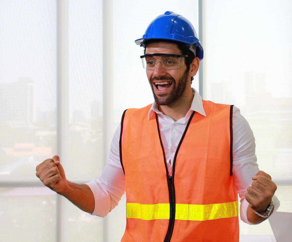 Confident man standing smiling at the construction site photo