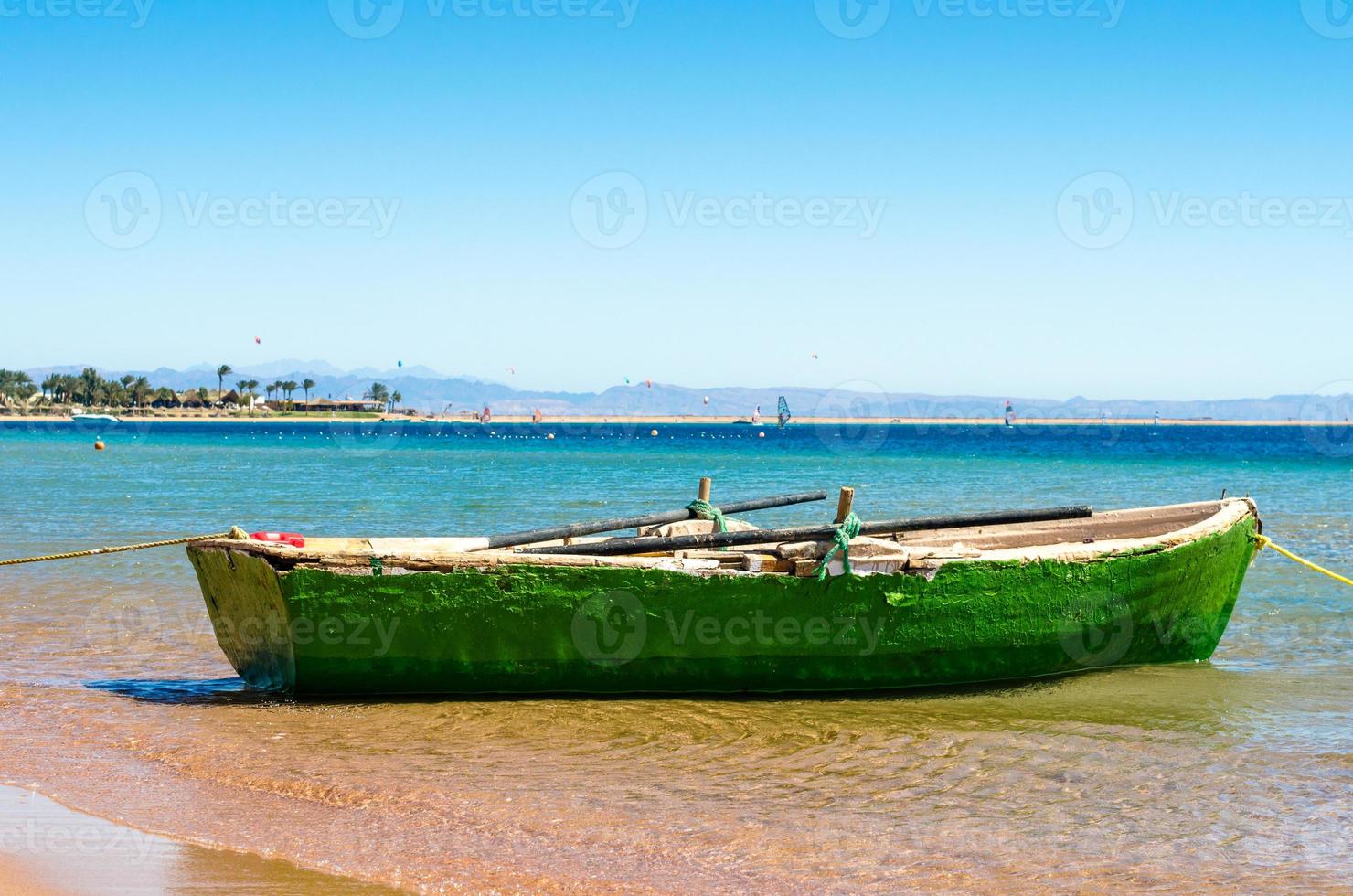 Old green boat in the water photo