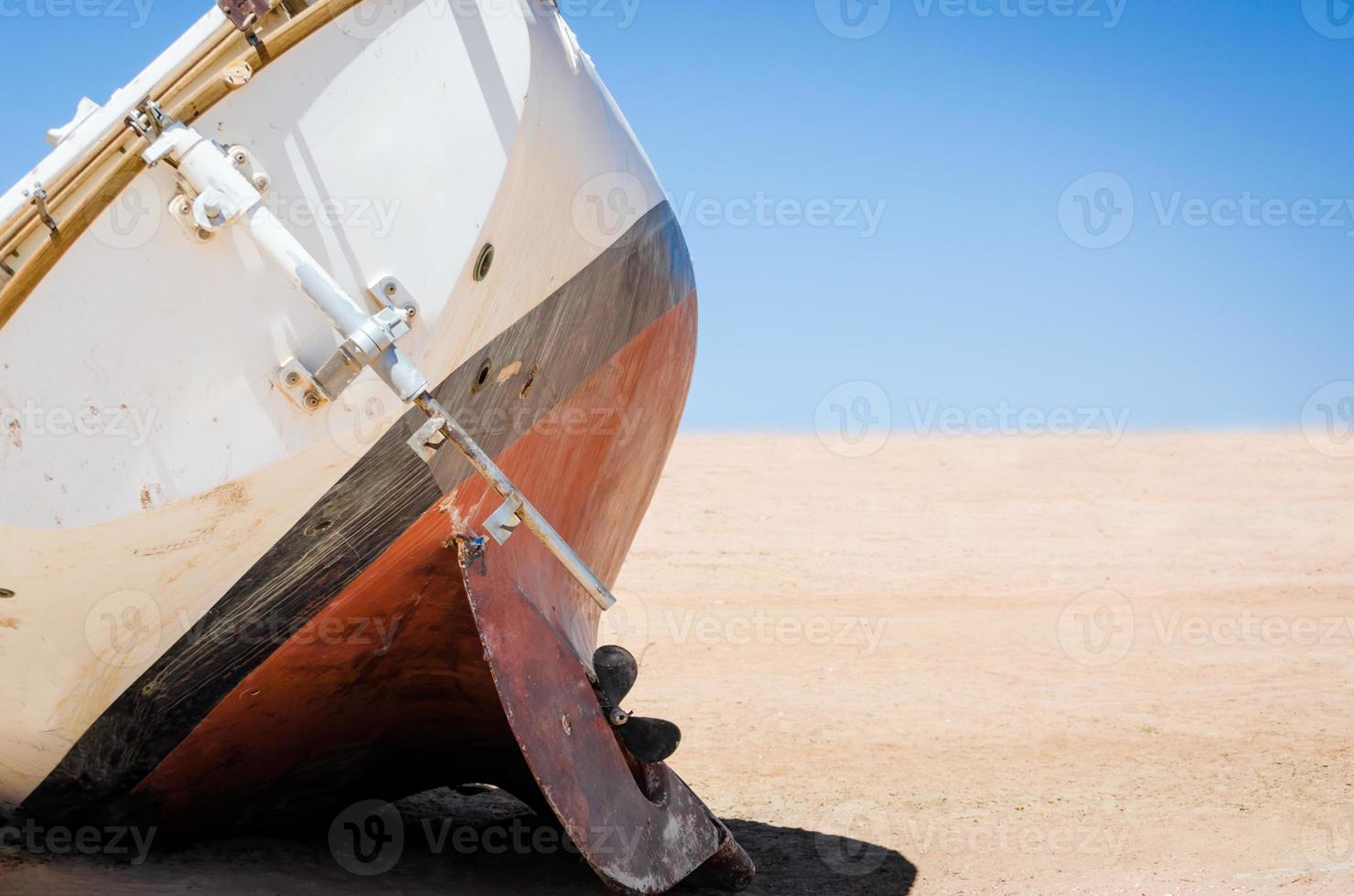 Abandoned old yacht on the sand photo