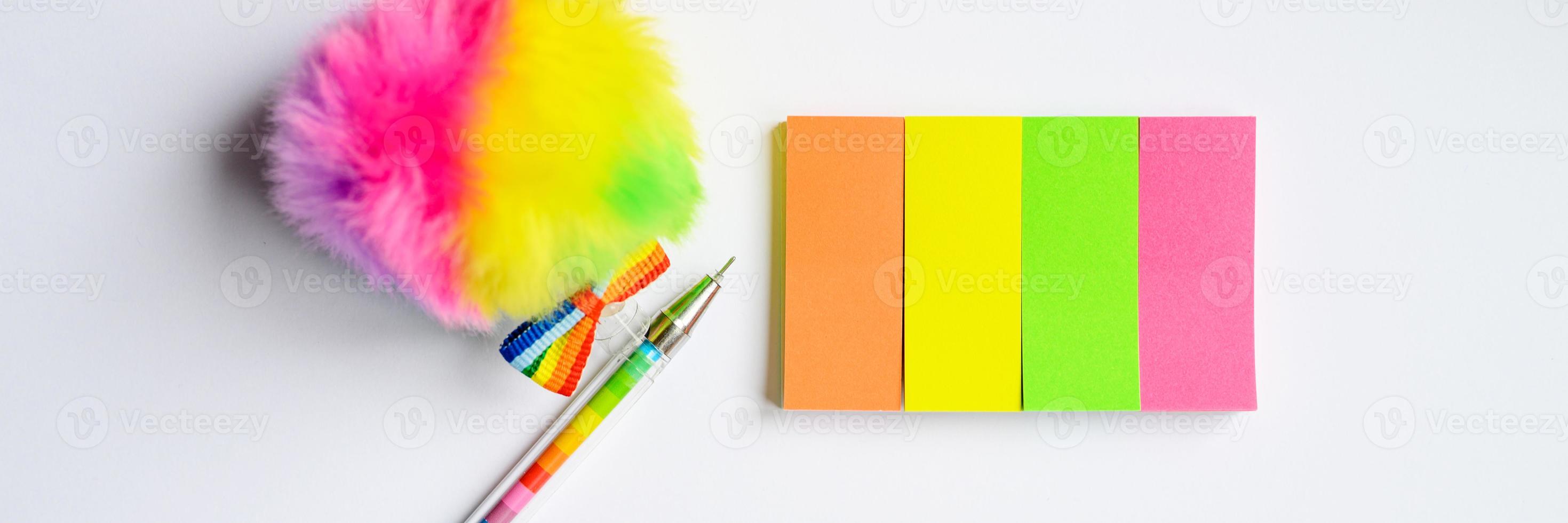 Multi-colored pen and stationary on white background photo