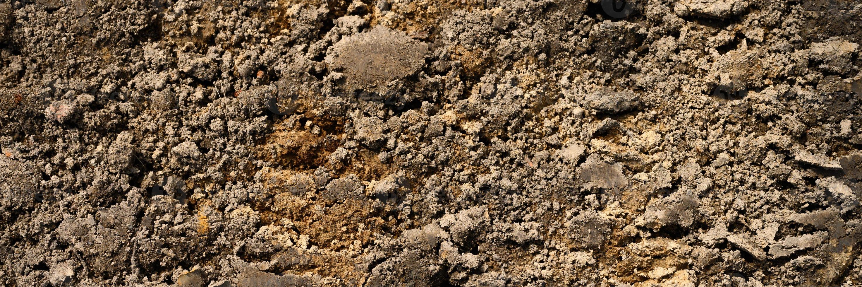 Background texture from the loose surface of the sand and earth soil photo