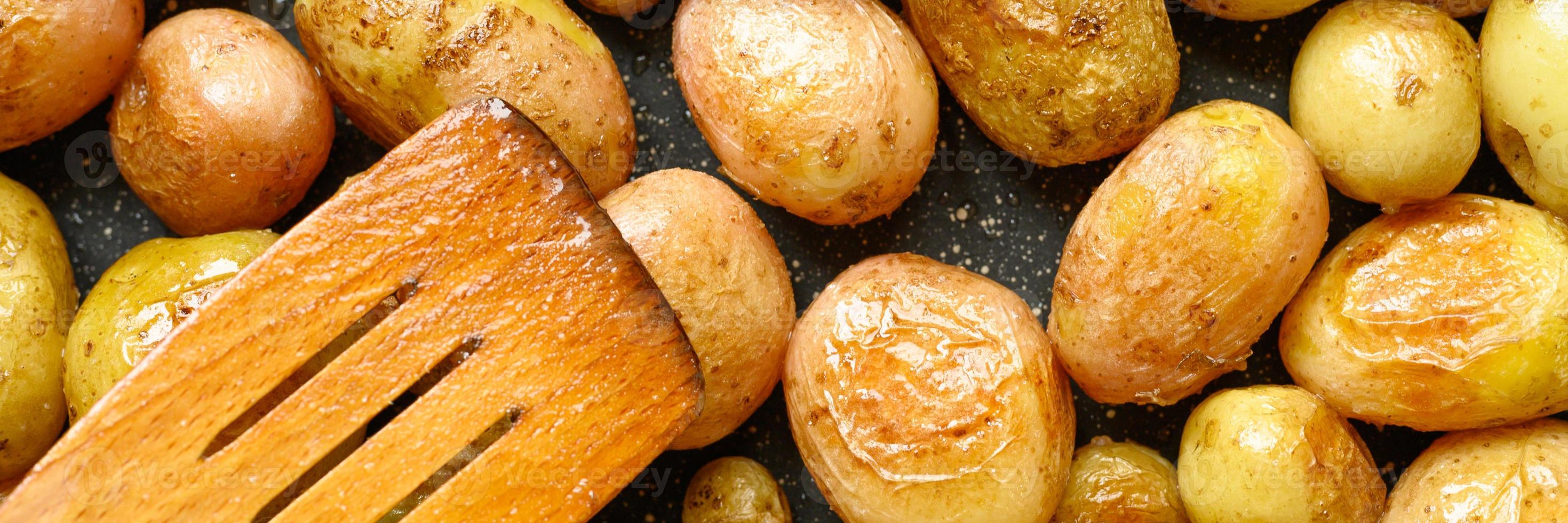 Golden roasted potatoes in the skin photo