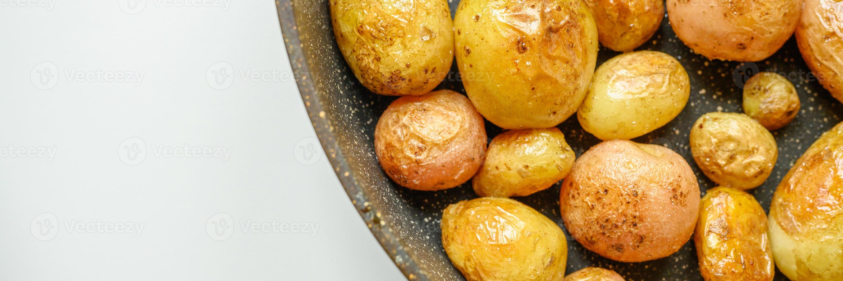 Golden roasted potatoes in the skin photo