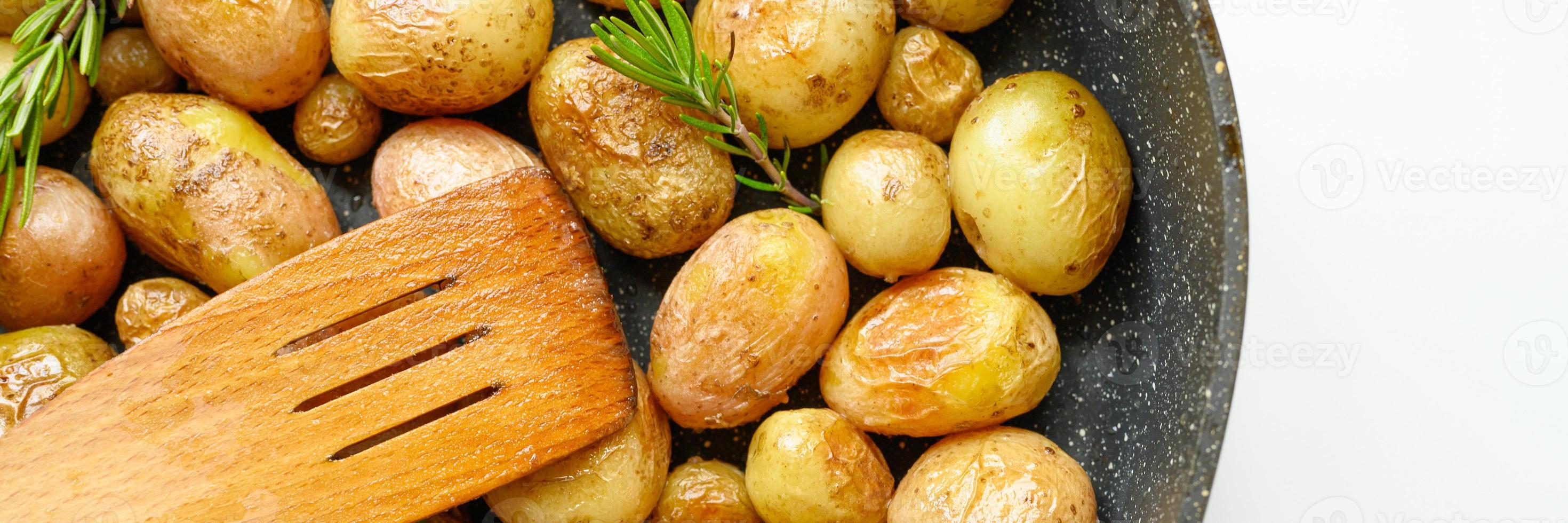 Golden roasted potatoes in the skin photo