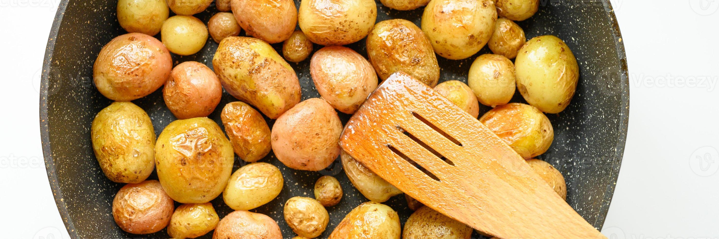 Golden roasted potatoes in the skin photo