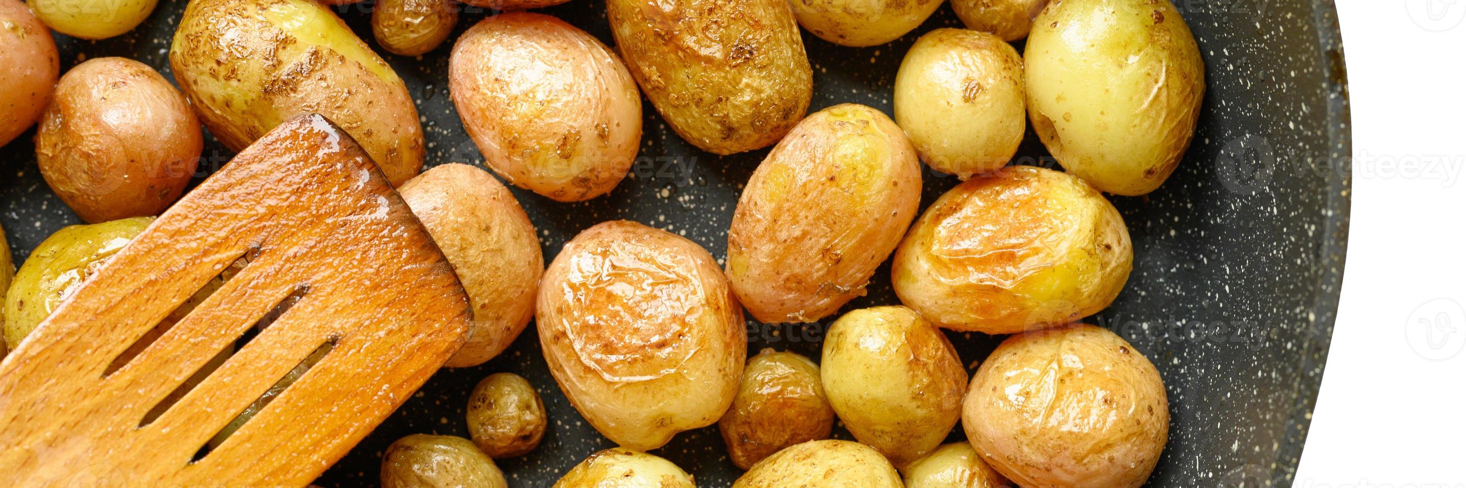 Golden roasted potatoes in the skin photo