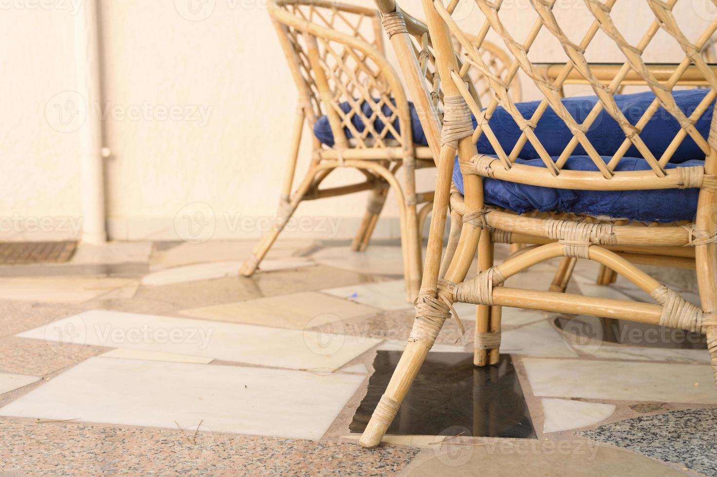 Wicker wooden chairs and coffee table for relaxing and socializing photo