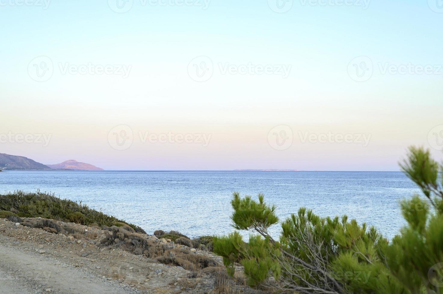 Seascape at dusk with background mountains photo