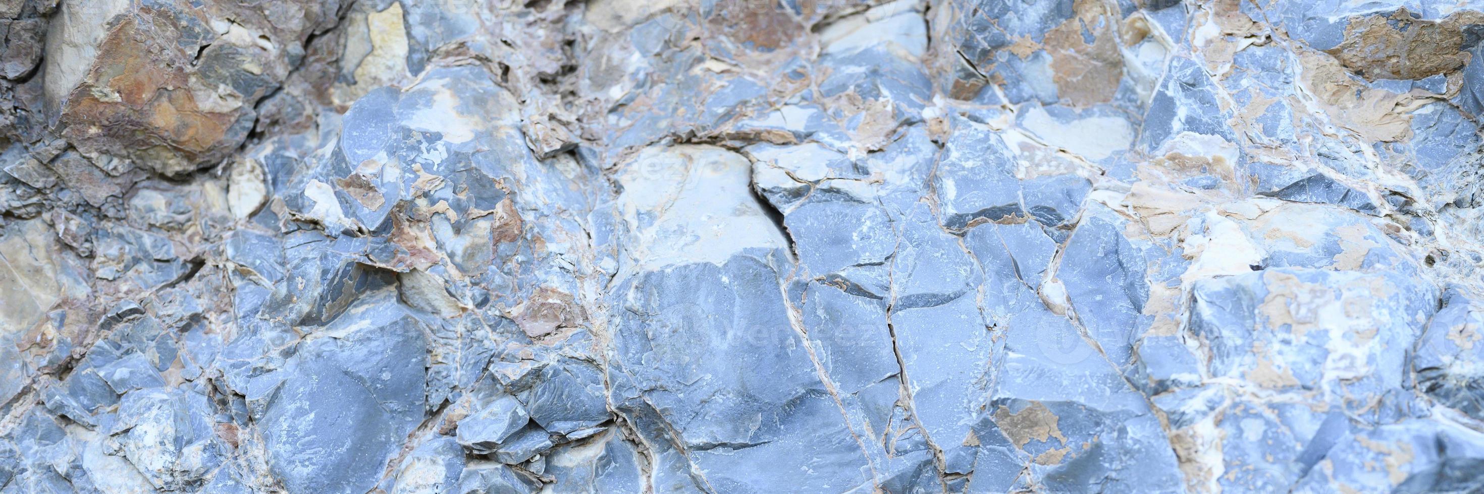 Texture of the surface of gray blue natural stone rocks photo