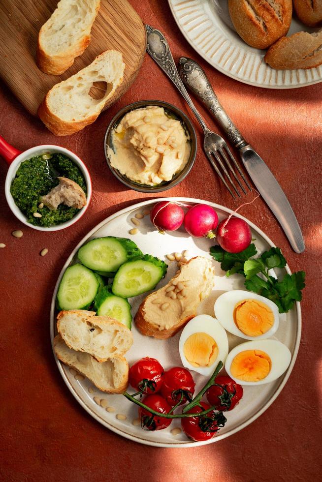 Mediterranean style breakfast plate on terracotta background photo