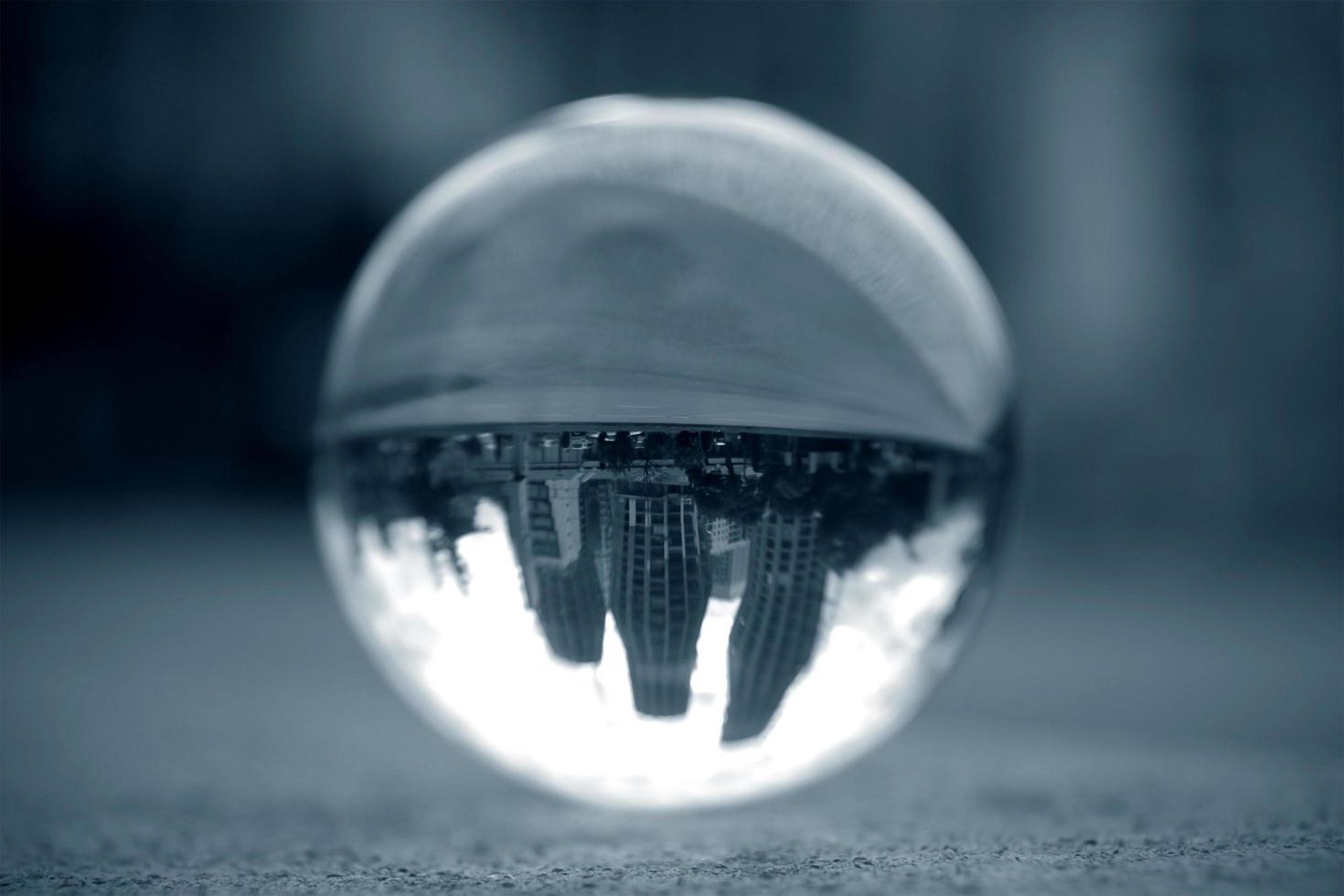 Lens ball with inverted buildings view in blue monocrome photo