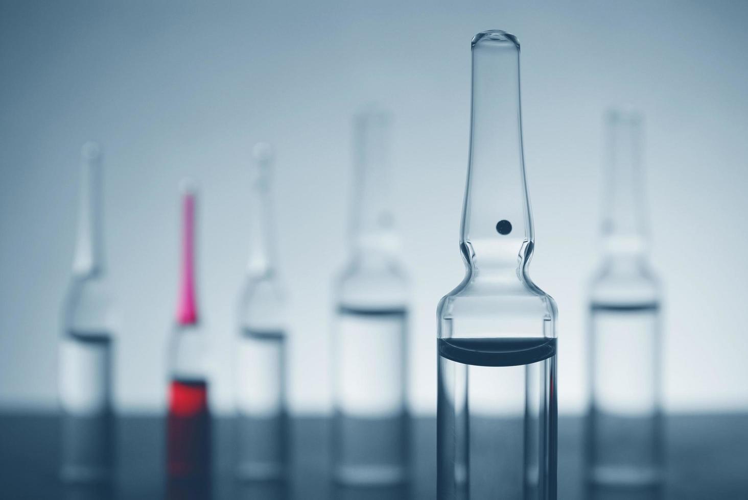 Glass apoules on futuristic background photo