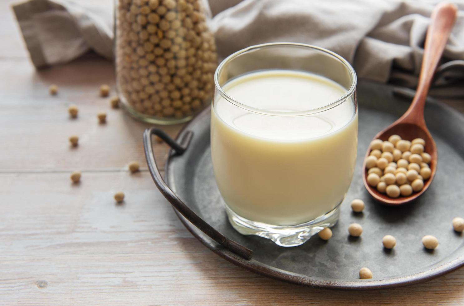 Soy milk and soy on a wooden table photo