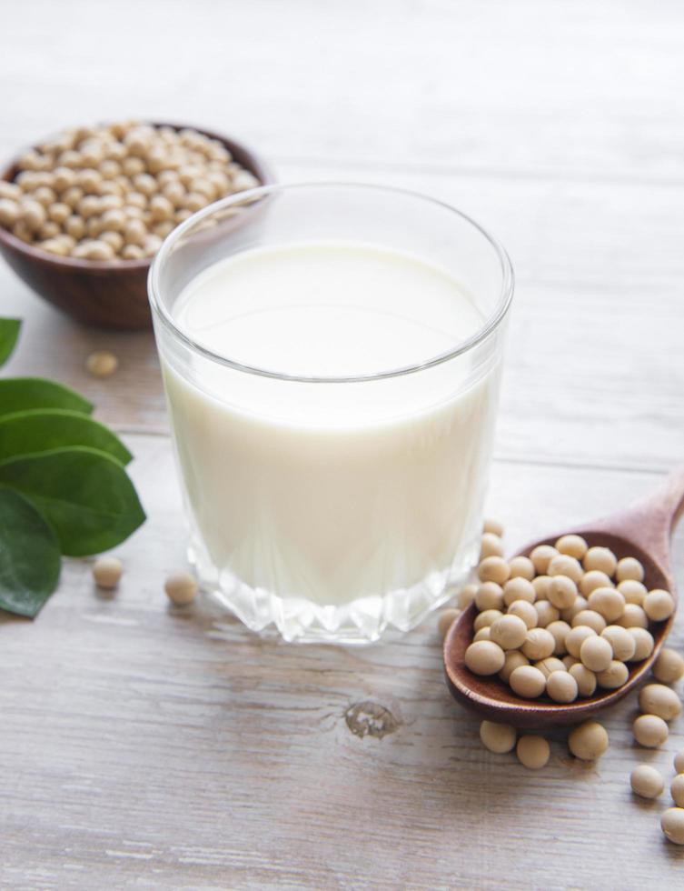 Soy milk and soy on a wooden table photo