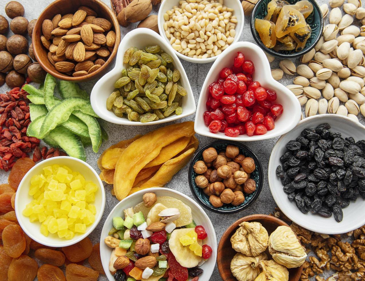 Bowls with various dried fruits and nuts photo