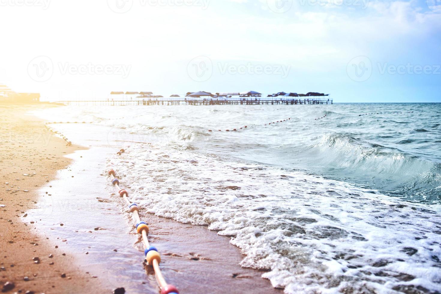 Sandy beach with waves from the sea photo