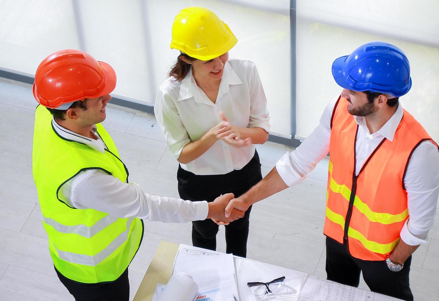 Architect engineer shaking hands in the office before supervising the construction site photo