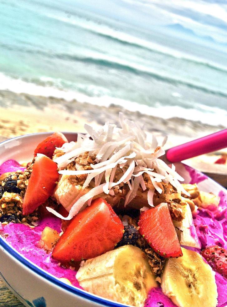 A bowl of pitaya by the beach photo