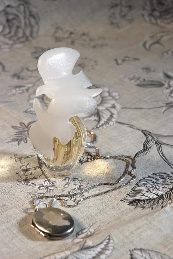 Perfume bottle on a floral dresser 2215447 Stock Photo at Vecteezy