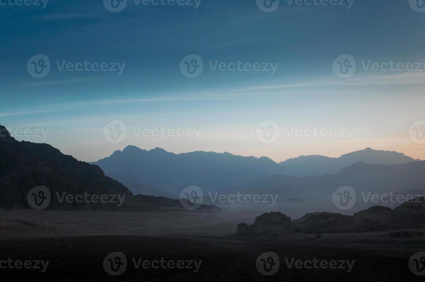 Dusk over rocky mountains photo