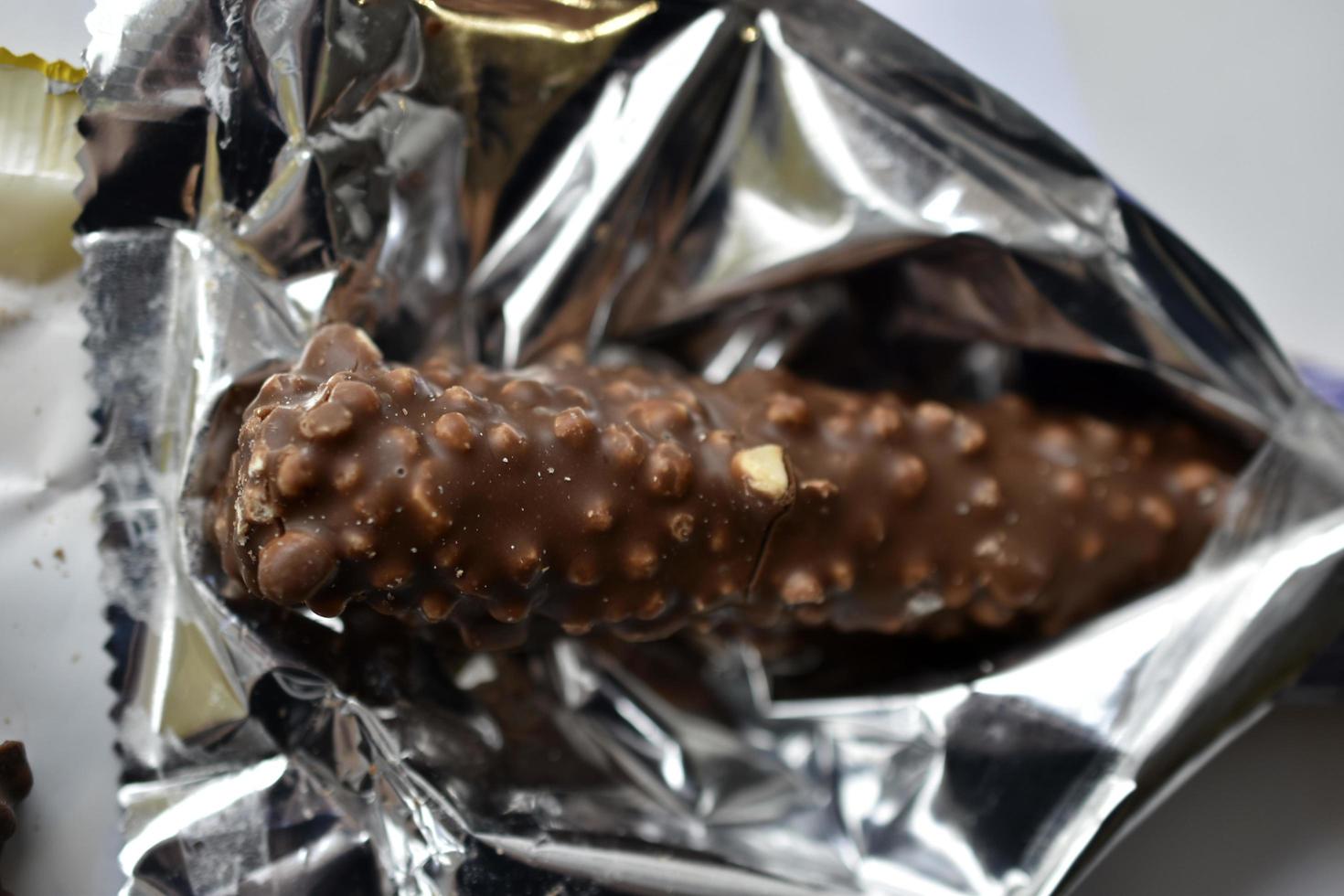 Delicious chocolate bar with nuts in a package photo