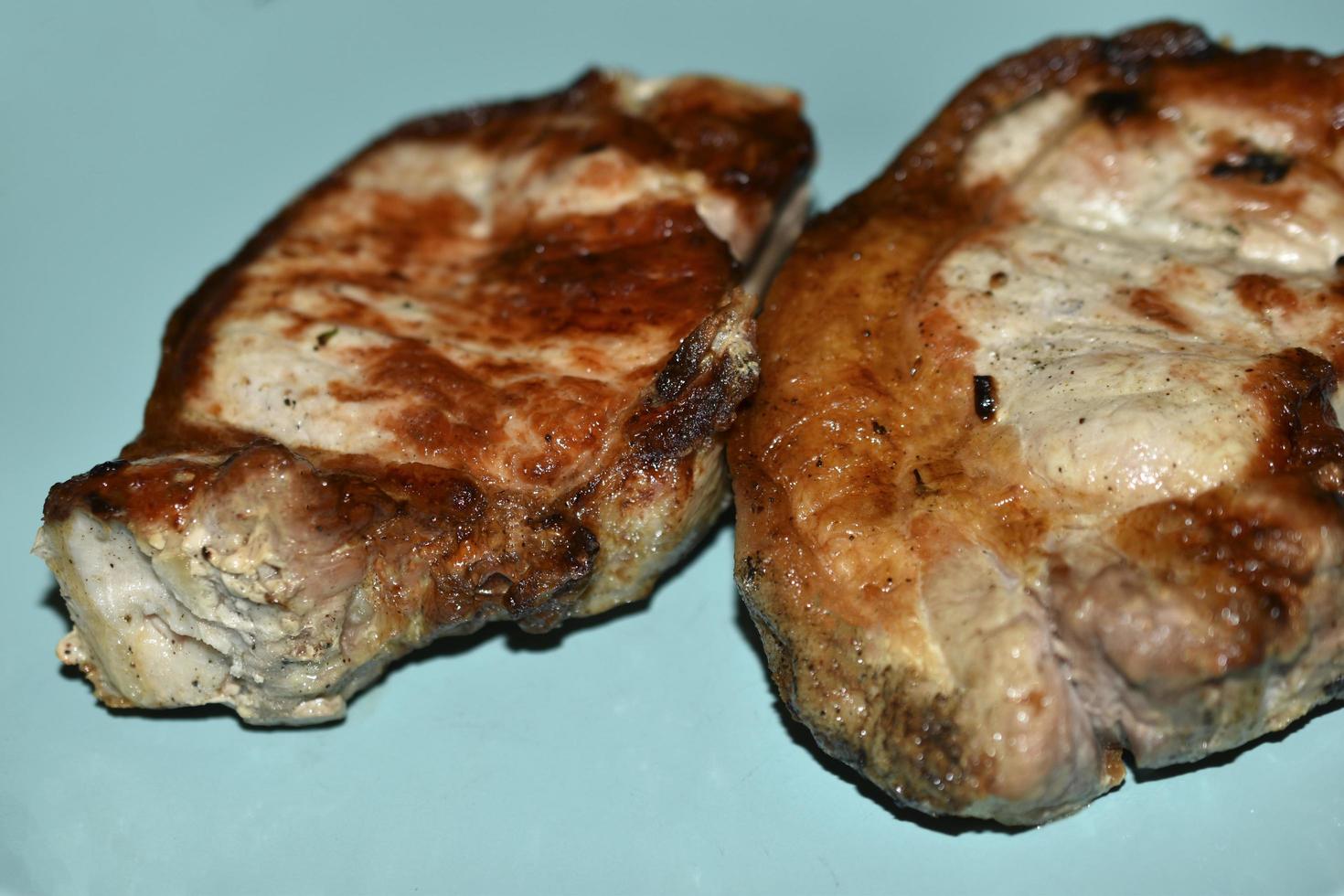 Chunks of delicious roast pork on a blue plate photo