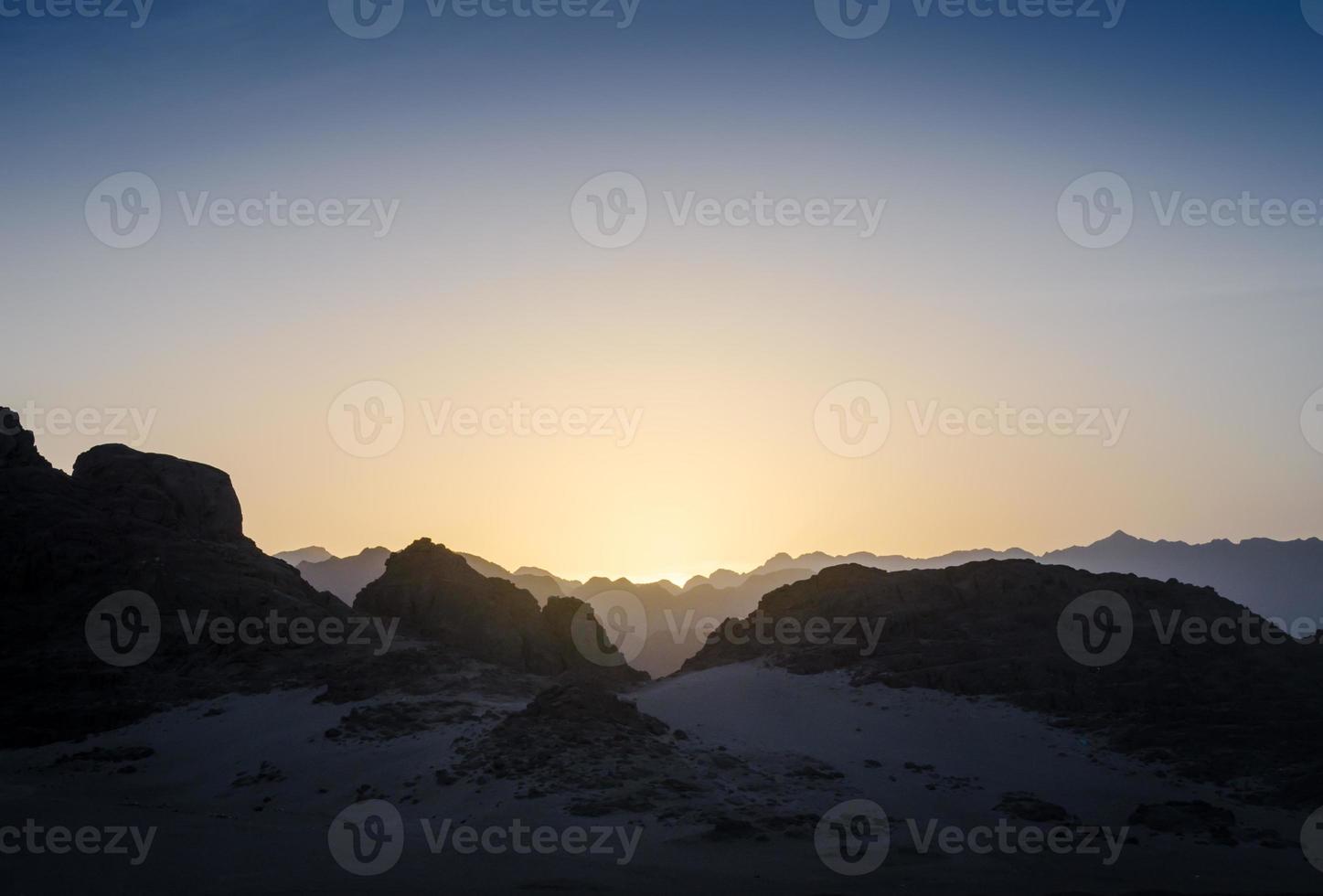 Peaks of mountains at sunset photo