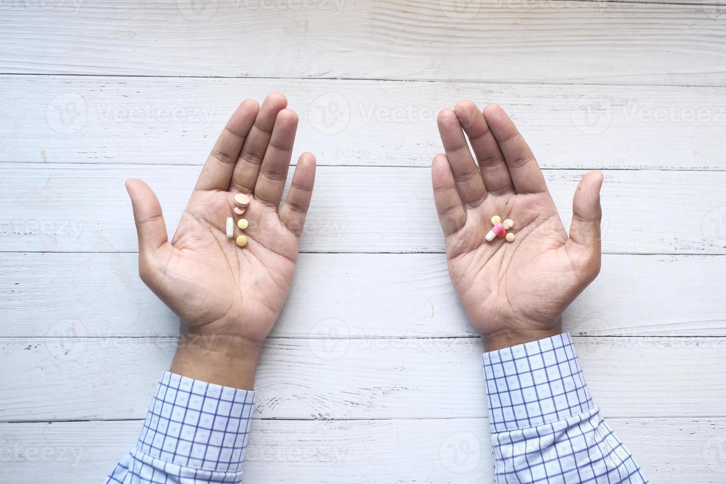 hombre con pastillas en ambas manos foto