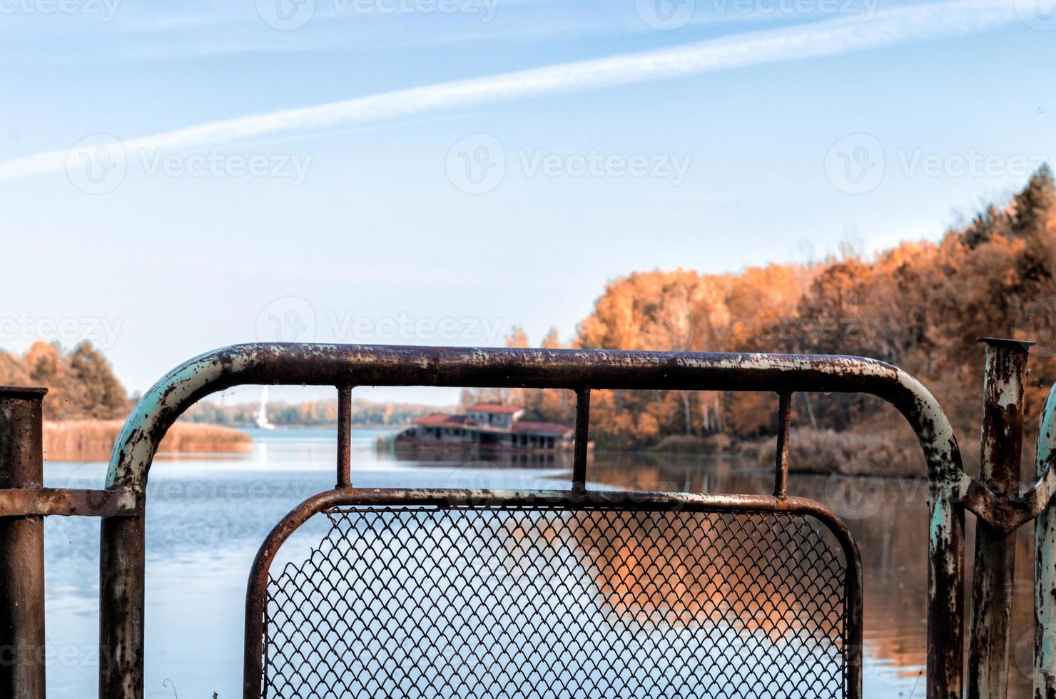 Pripyat, Ukraine, 2021 - Iron fence near water in Chernobyl photo