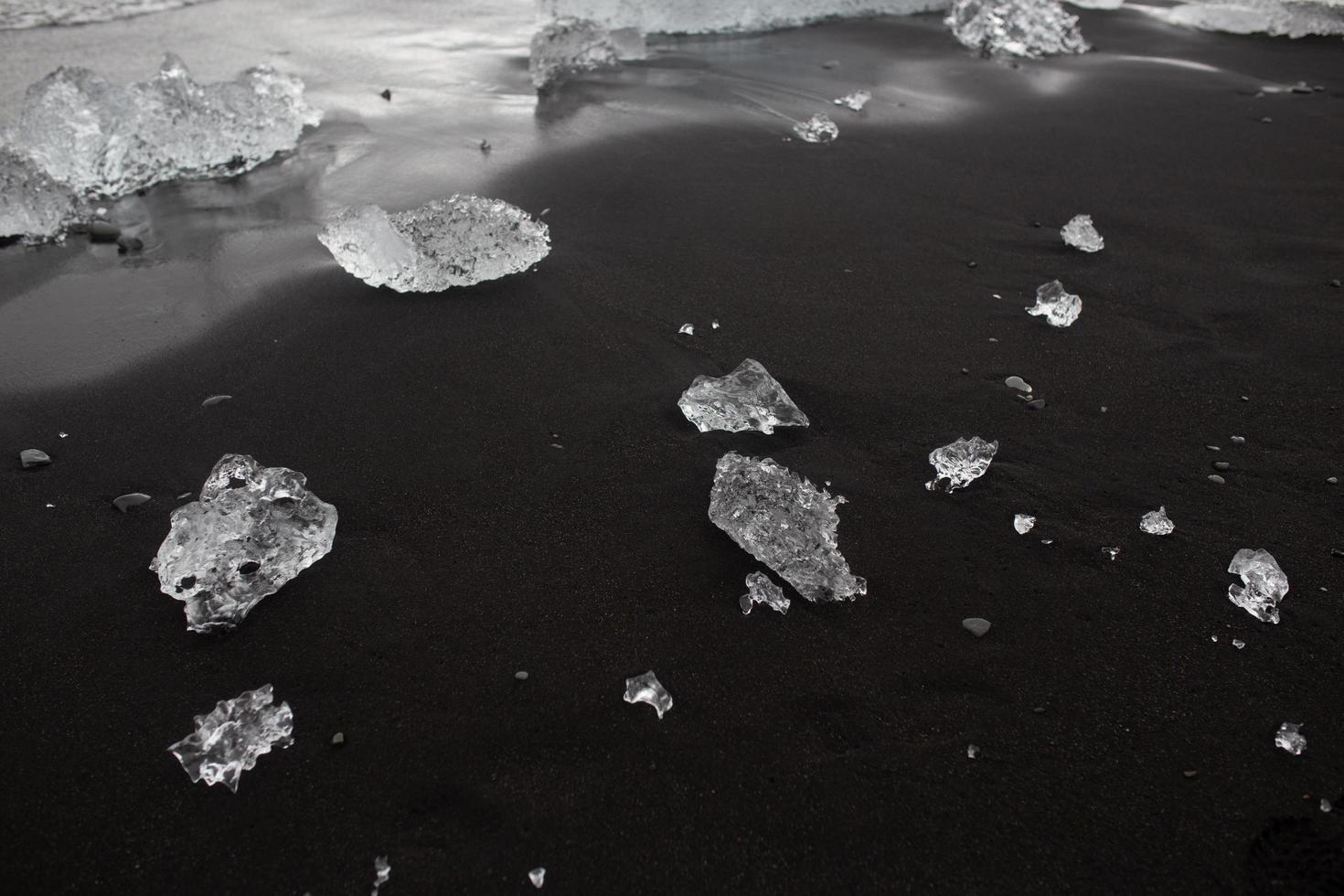 Ice on black beach in Vik, Iceland photo