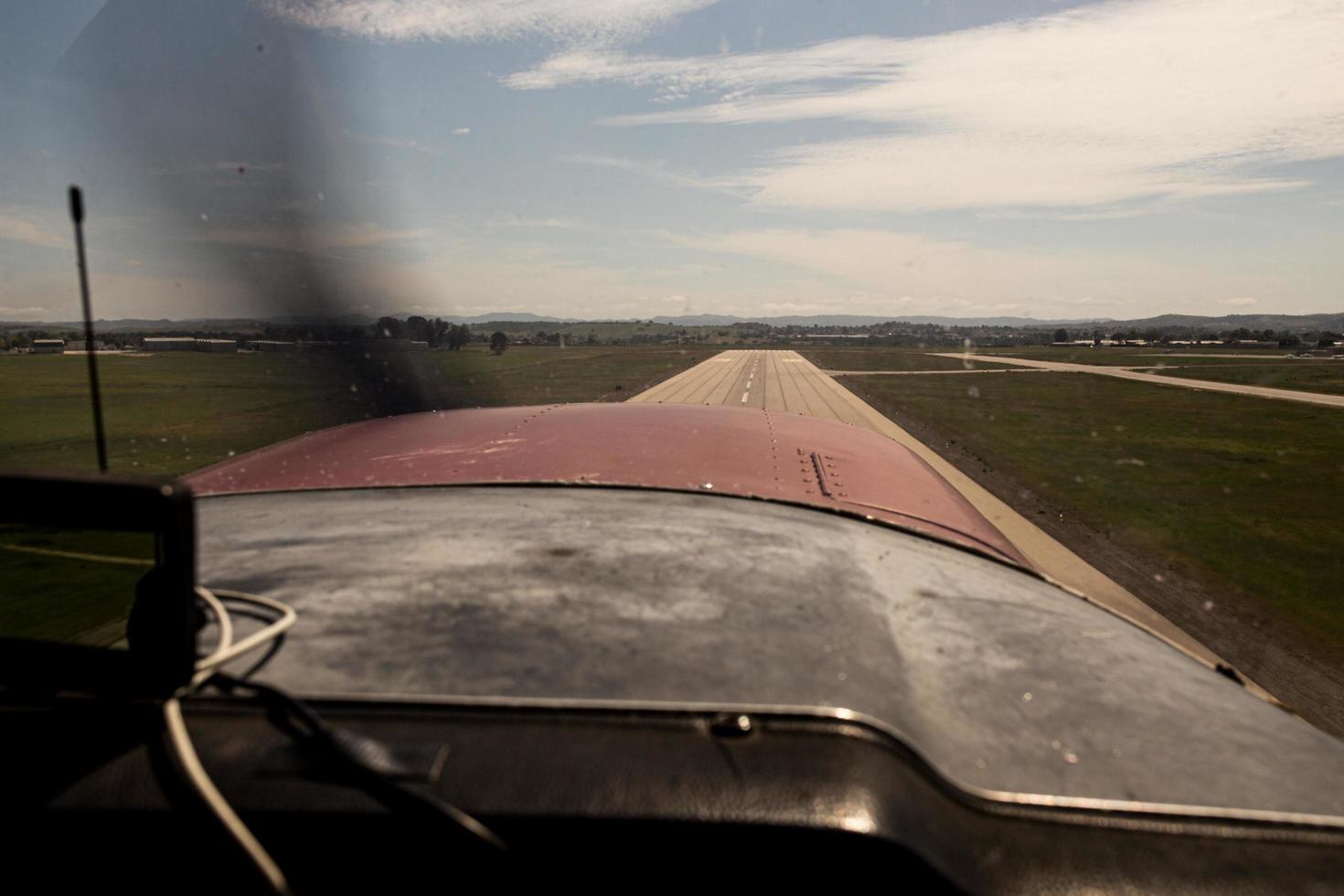 Small plane landing on a runway photo