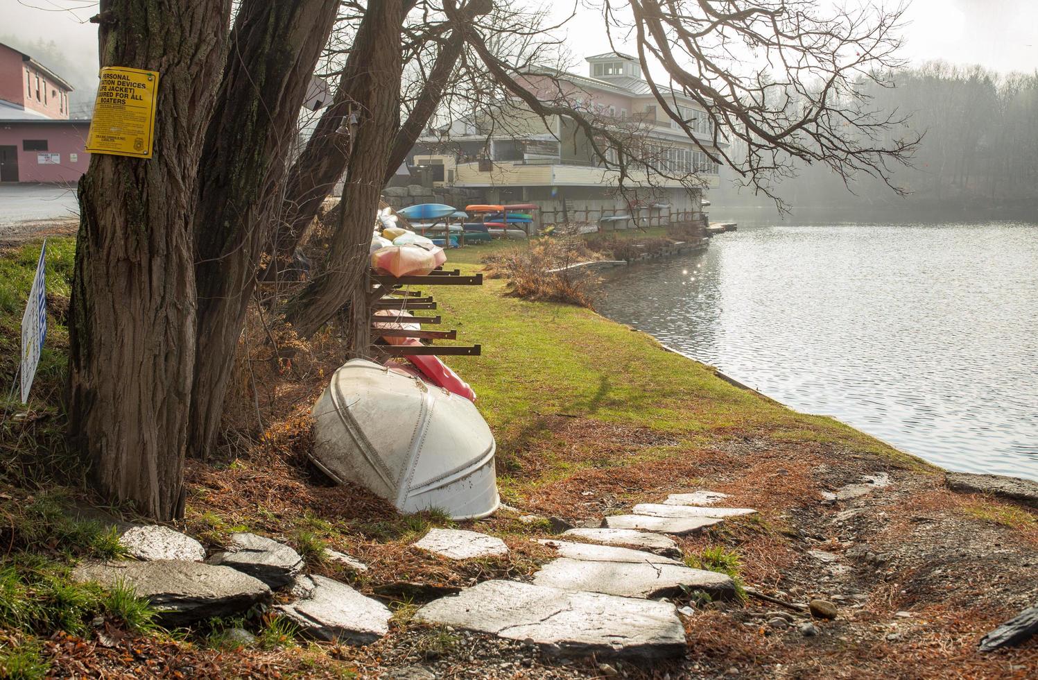 Canoes and kayaks on the river bank photo