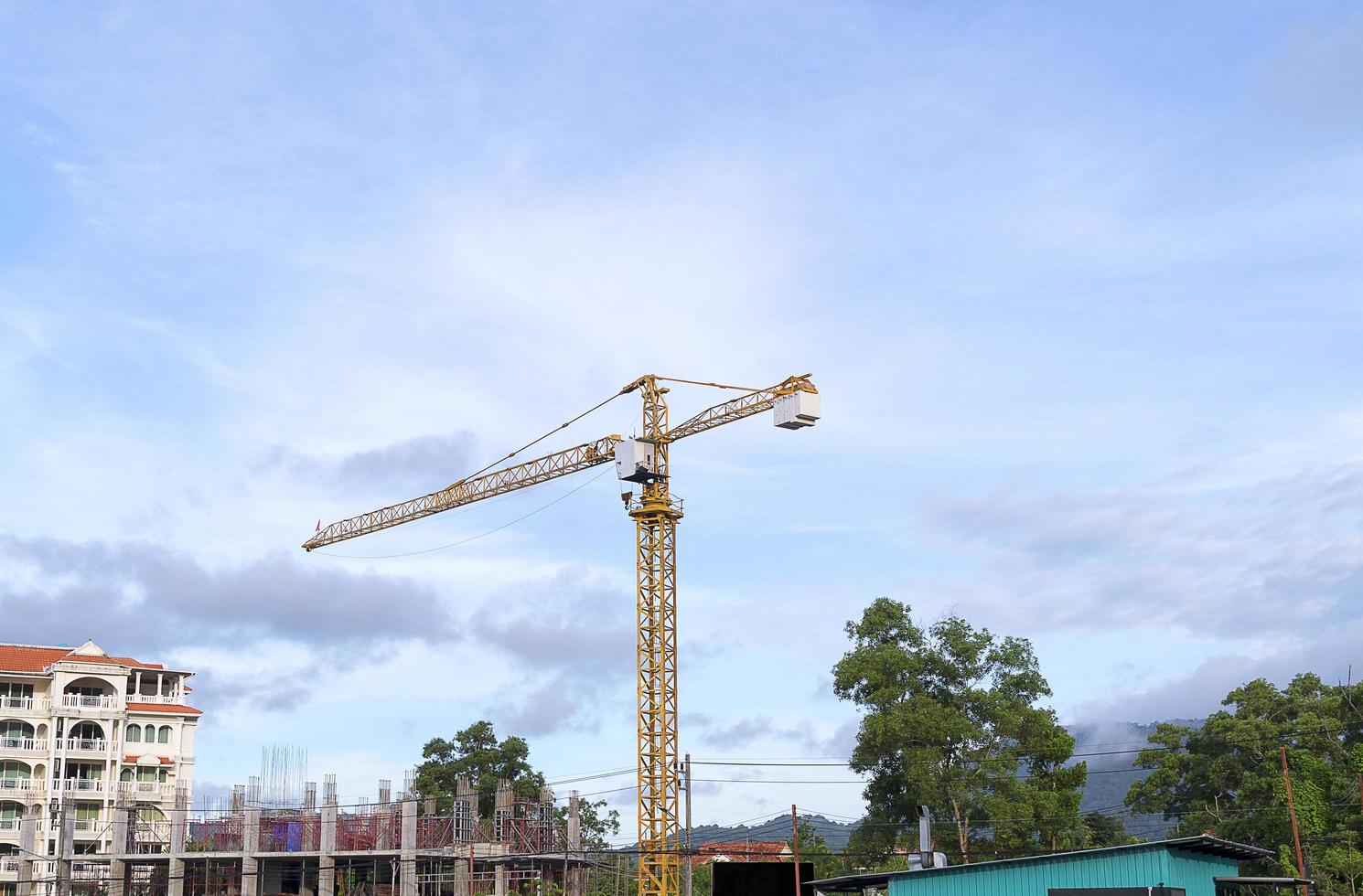 Yellow construction tower crane photo