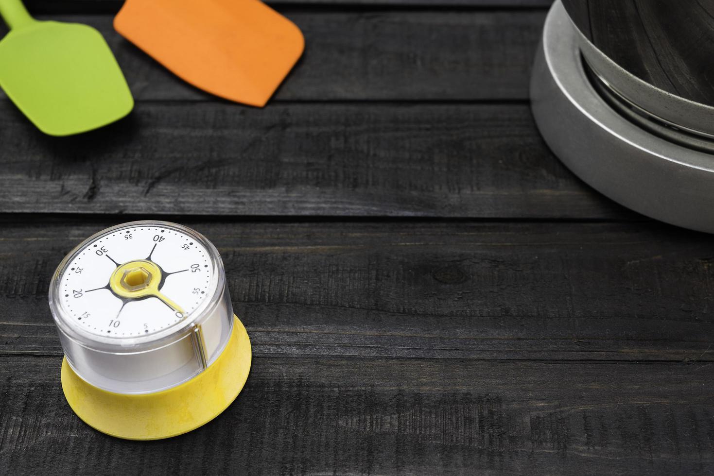 Bakery and cooking tools with a kitchen timer on a wooden table photo