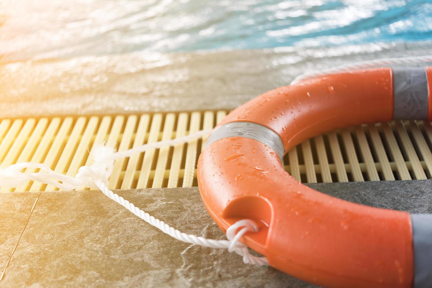 Orange floatation device by a swimming pool photo