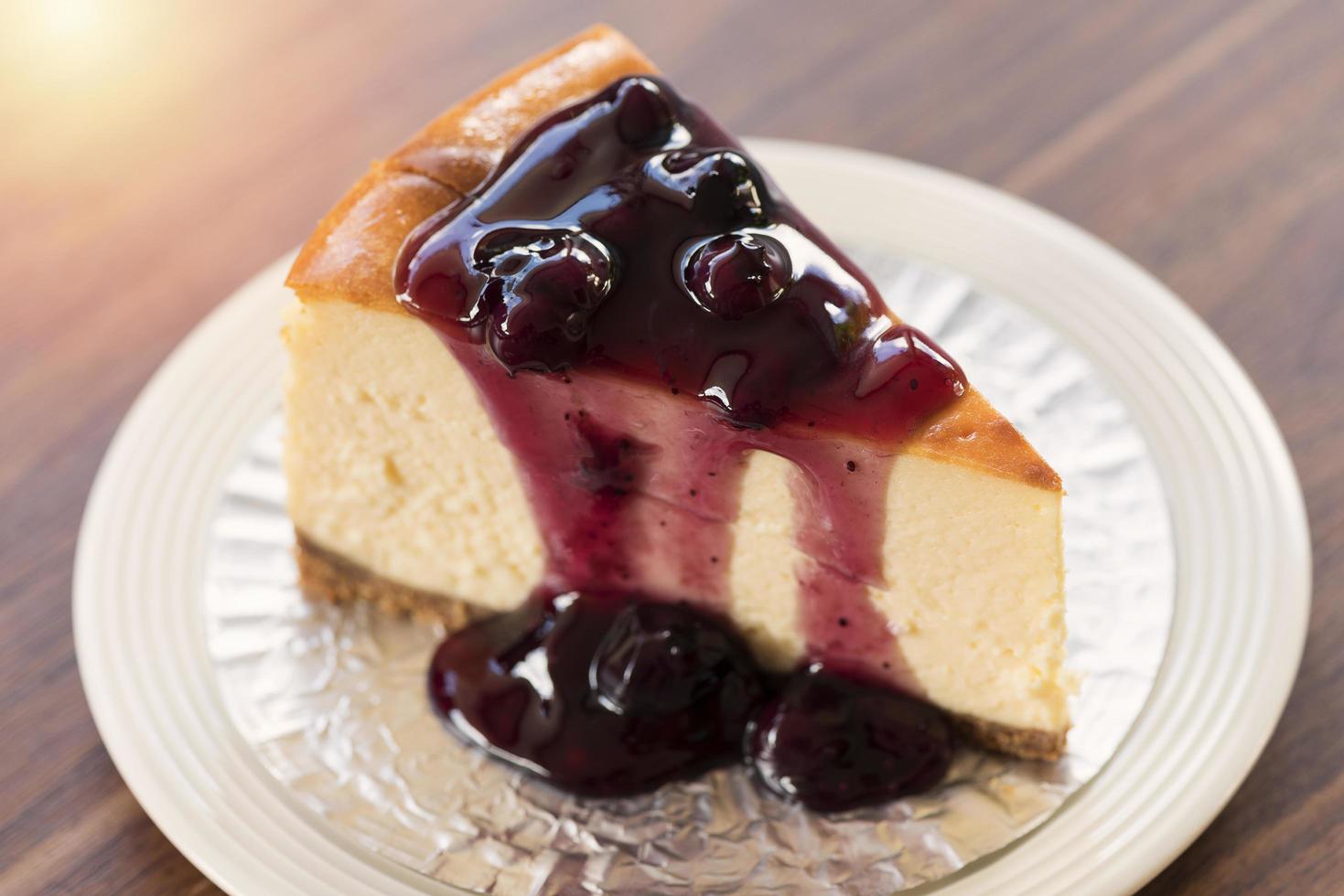 Homemade blueberry New York cheesecake on a white plate photo