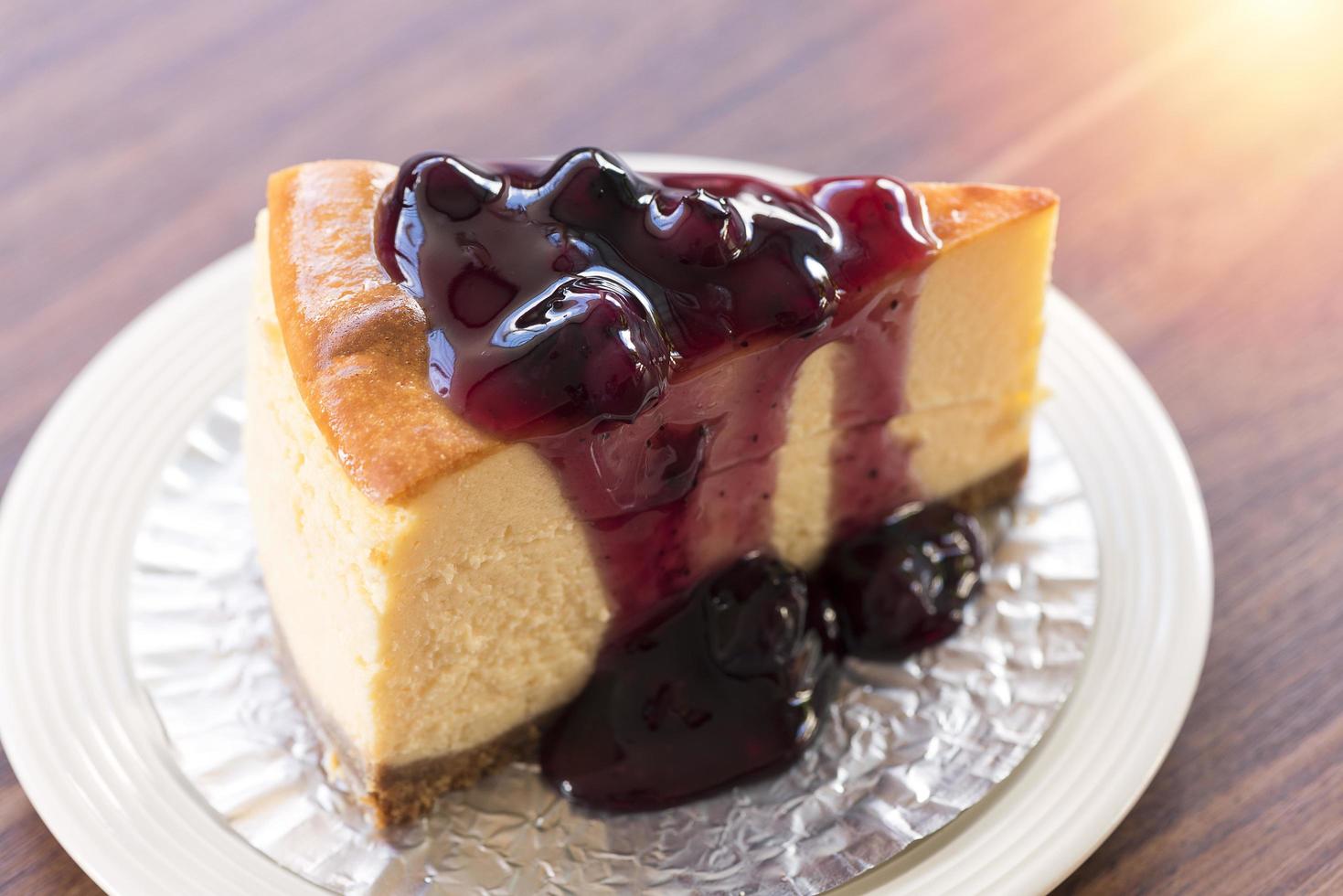 Homemade blueberry New York cheesecake on a white plate photo