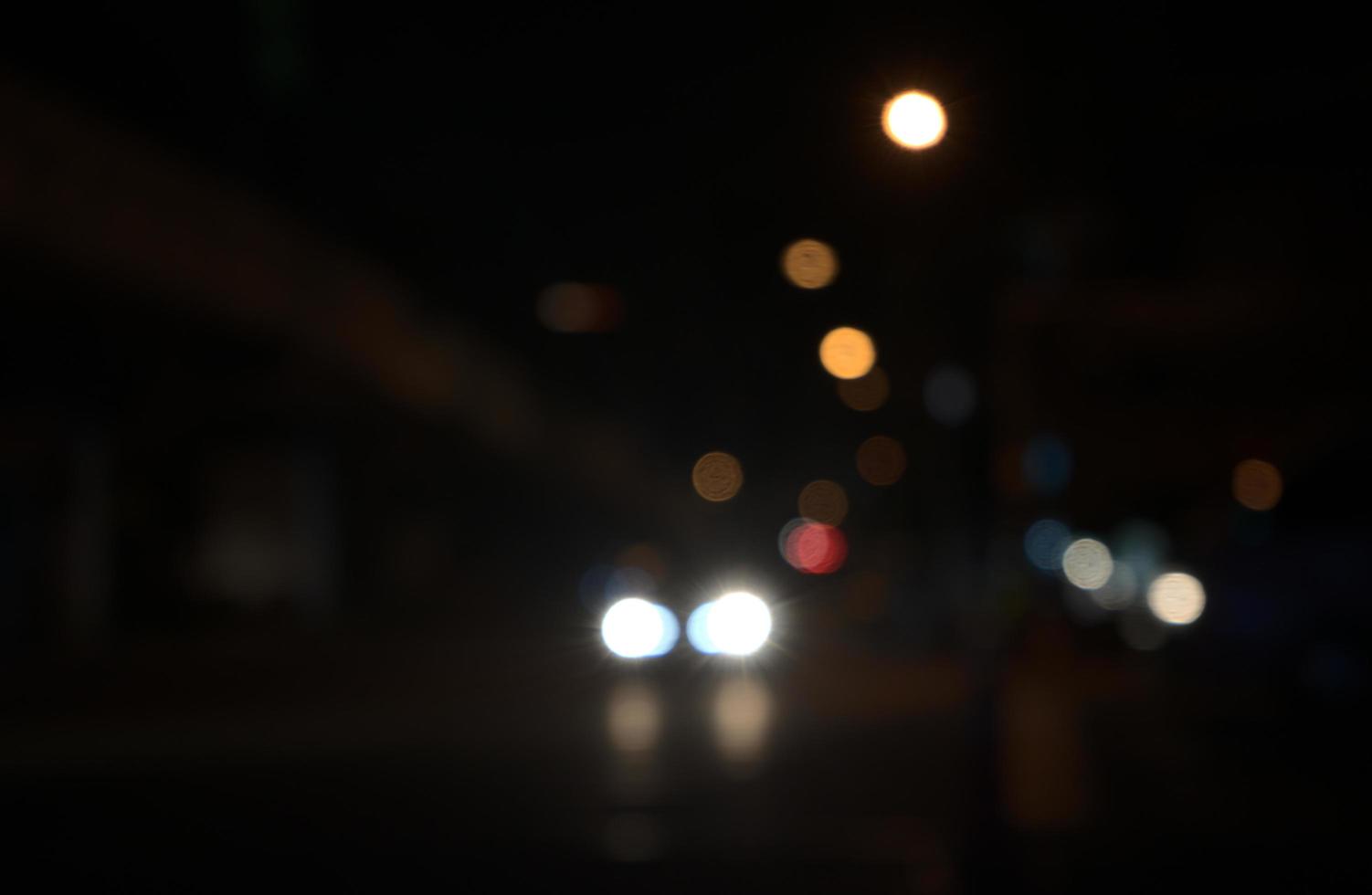 Blurry lights of car, city in public road photo