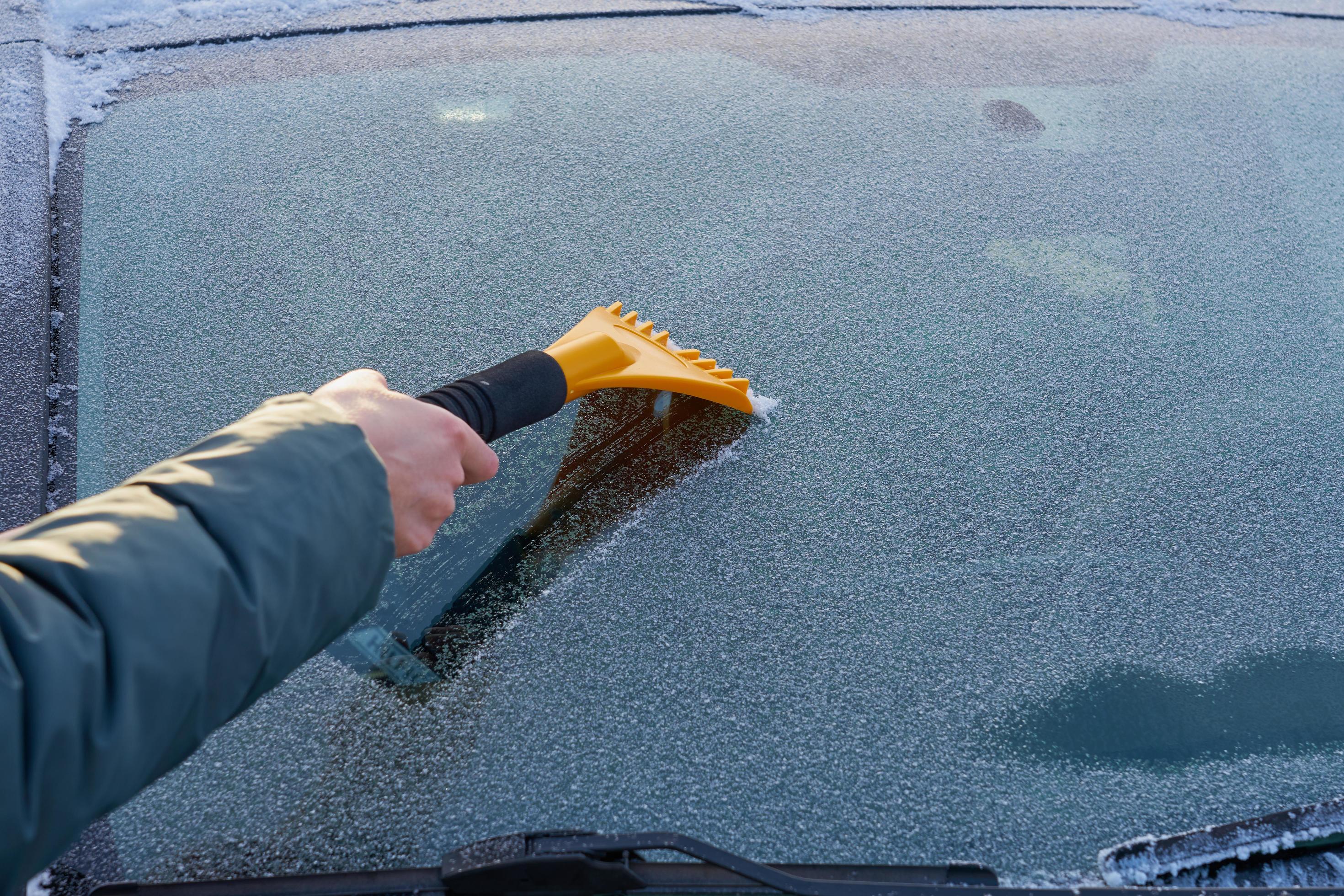 Scraping ice off a windshield 2222963 Stock Photo at Vecteezy