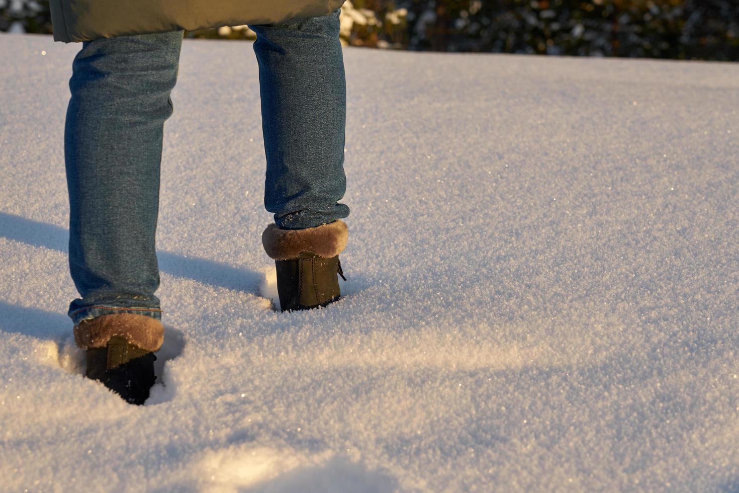 Close-up of a person walking through the snow photo