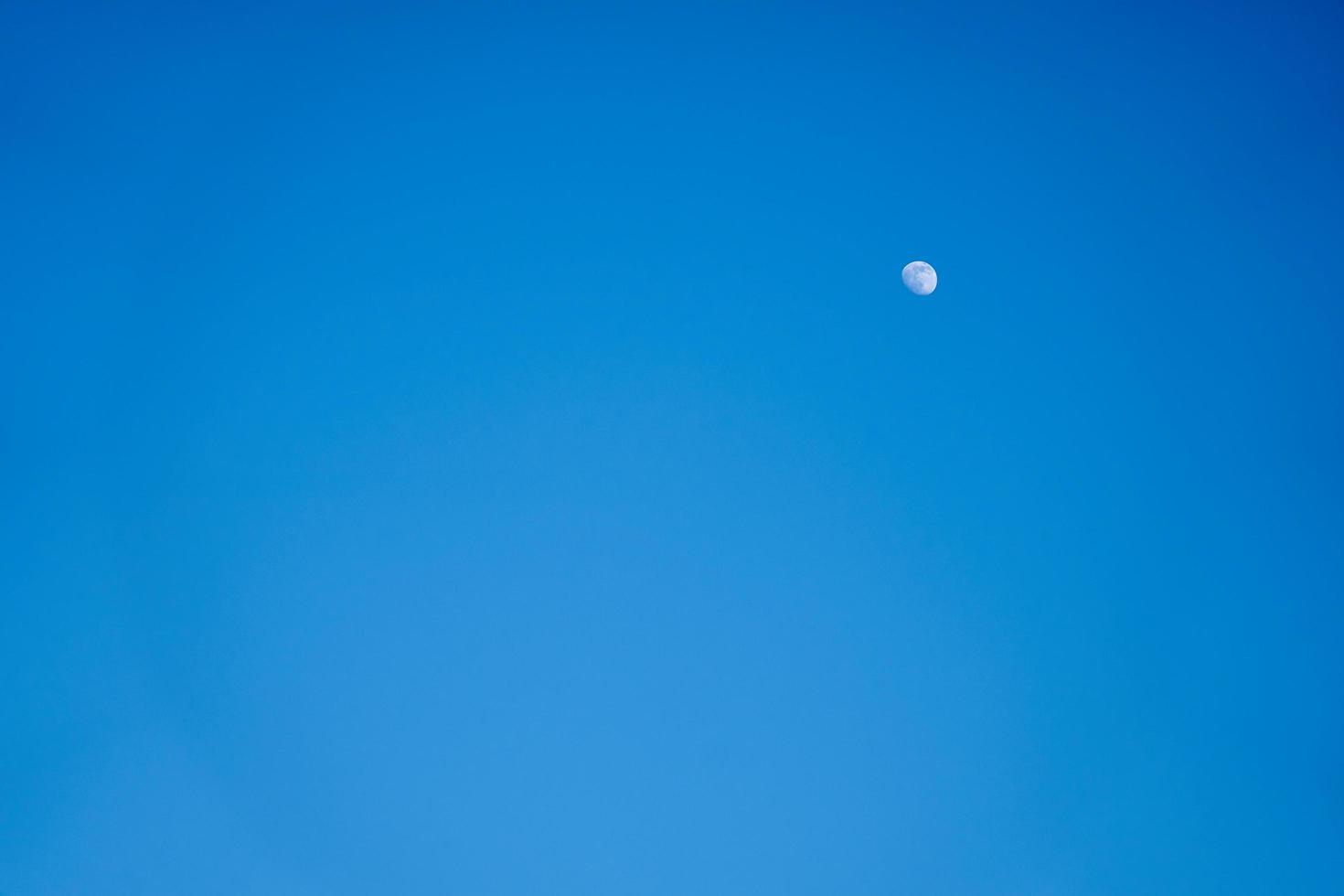 Moon in a blue sky photo