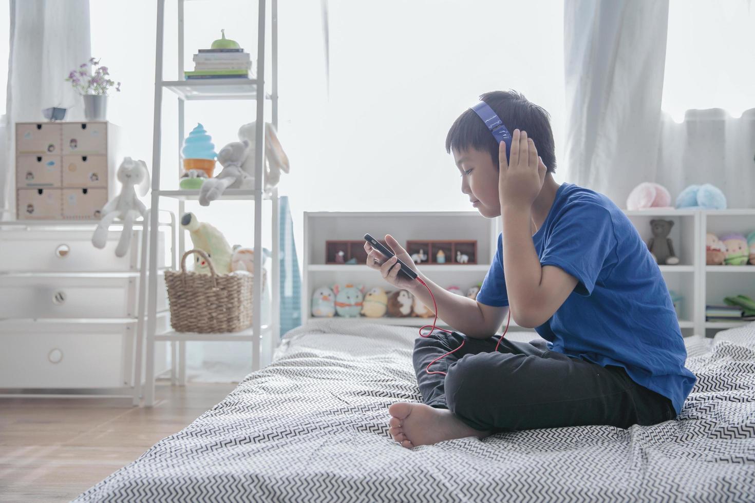 Boy listening to music with headphones on photo