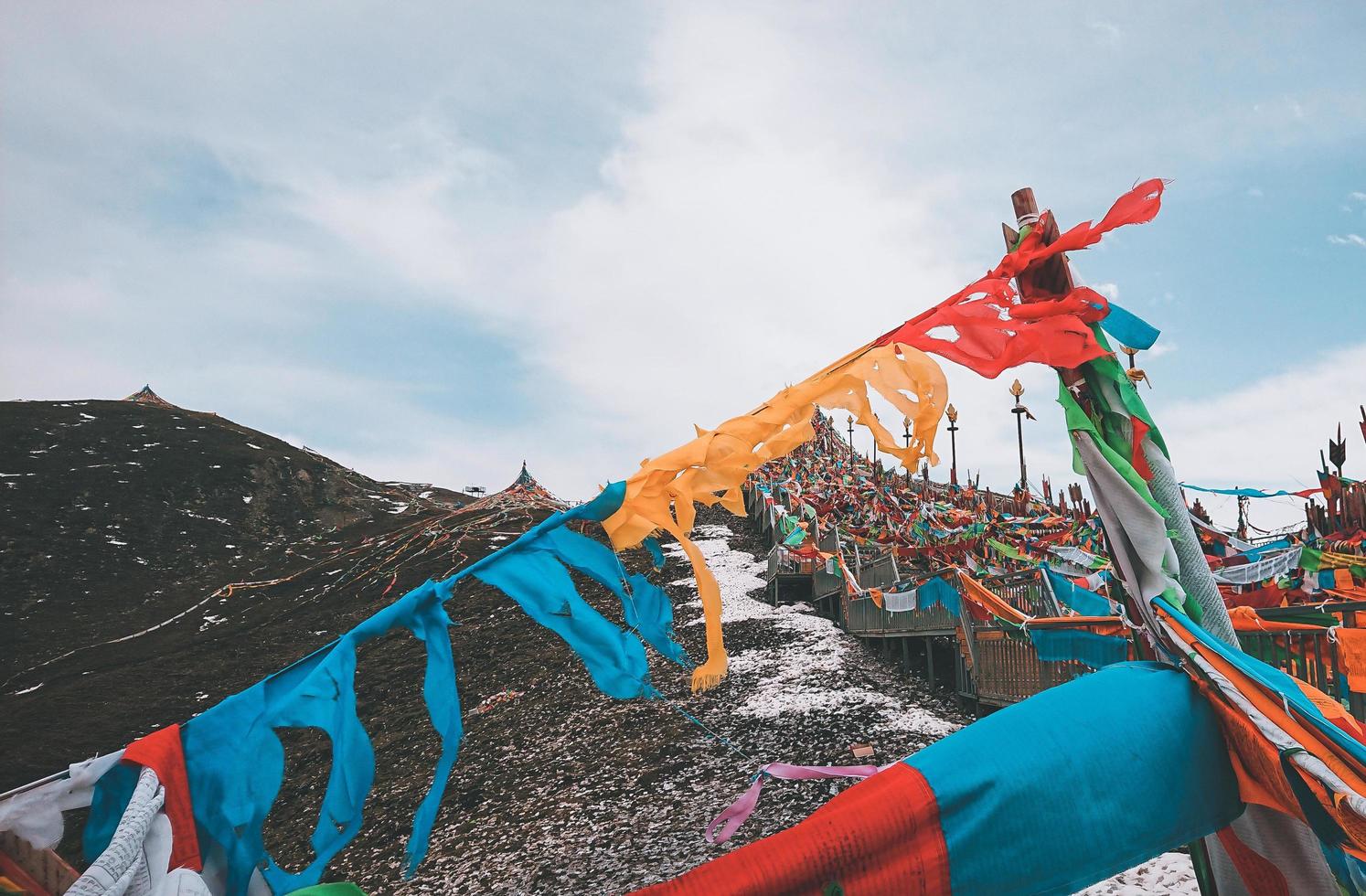 Colorful prayer flags along a bridge photo