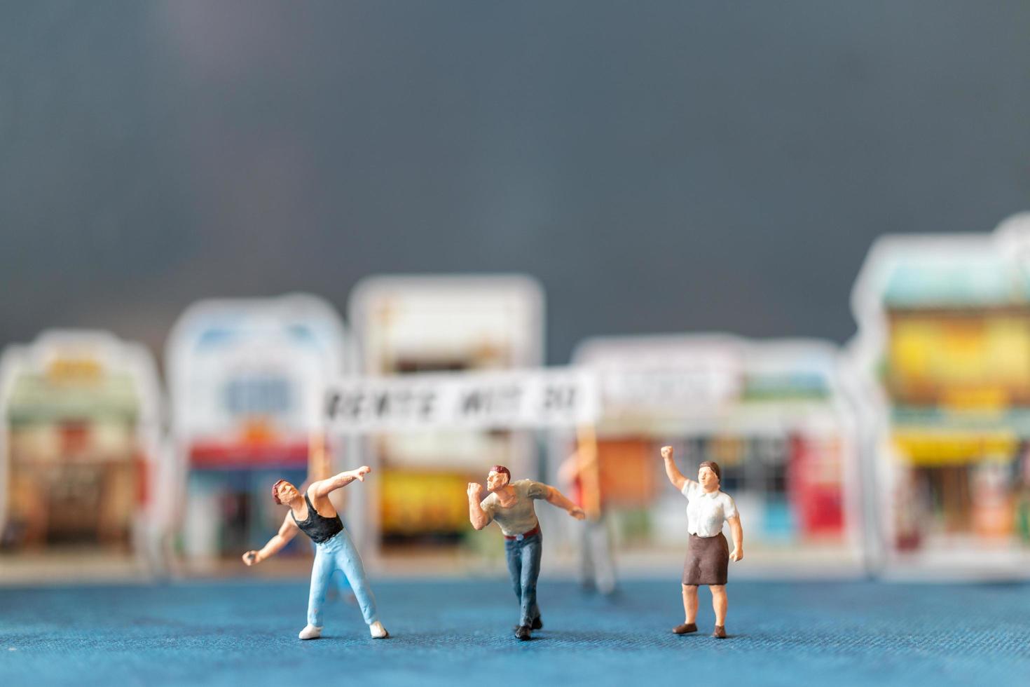 Miniature people, protesters holding signs, raising their hands for revolution, protesting concept photo