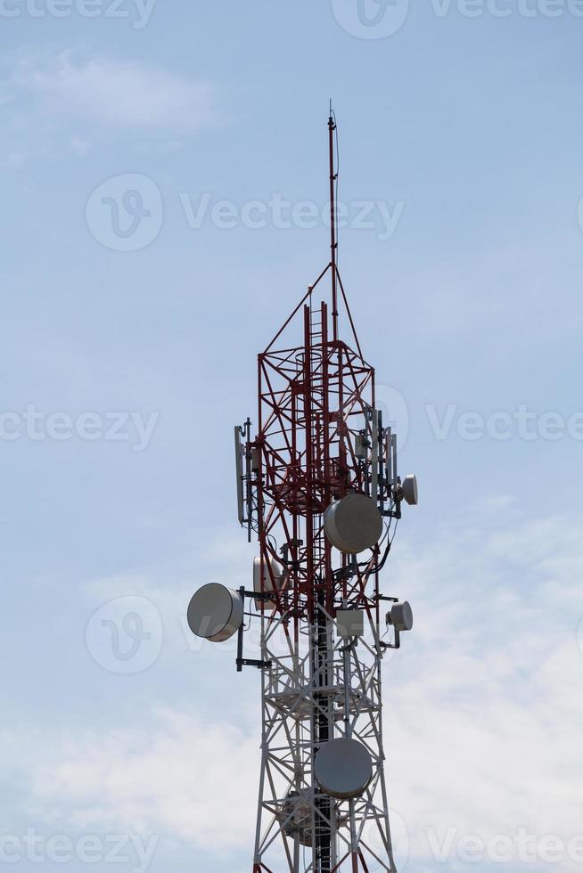 Telecommunication tower in a cloudy sky background photo
