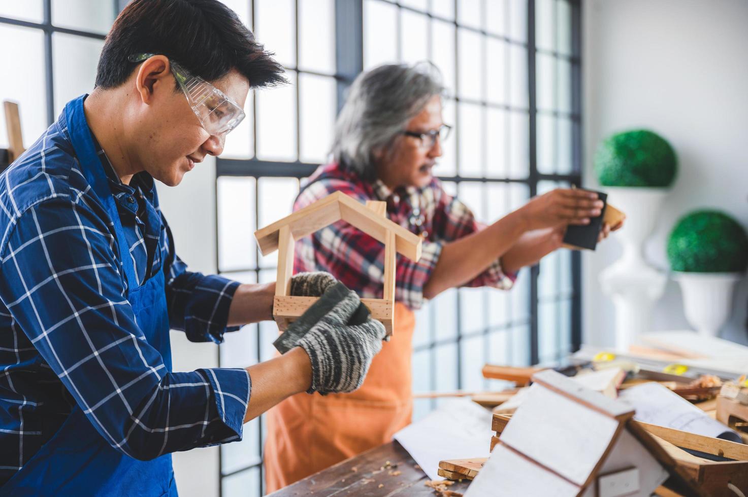 Two carpenters making a birdhouse photo