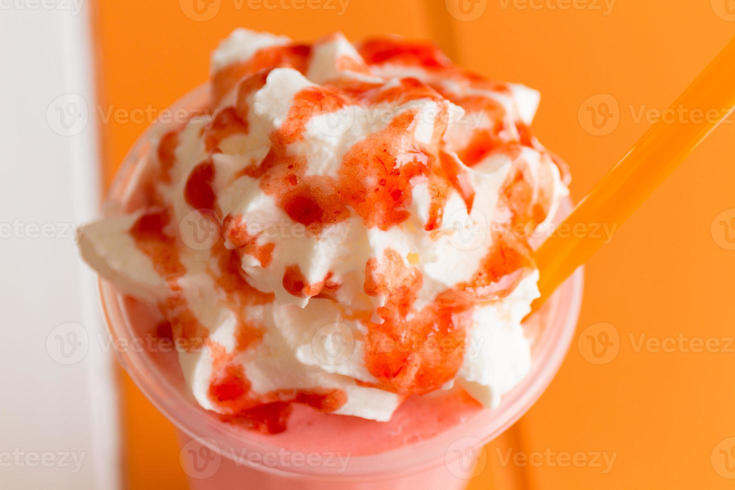 Sweet strawberry milkshake frappe, iced and milk blended with whipped cream photo