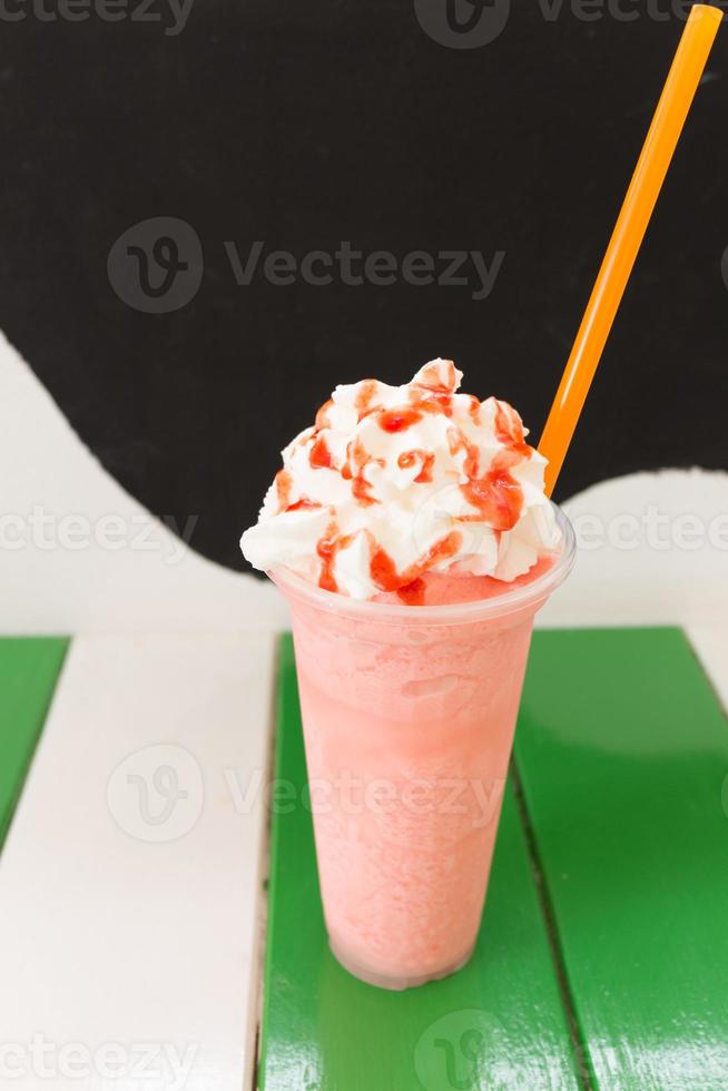 Sweet strawberry milkshake frappe, iced and milk blended with whipped cream photo